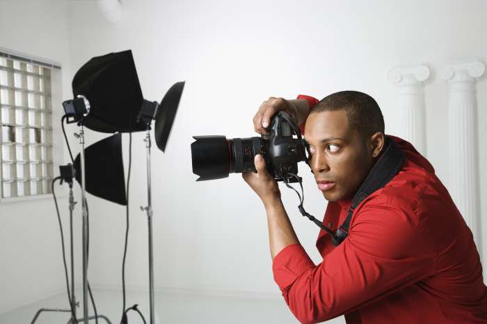 young male photographing in studio.