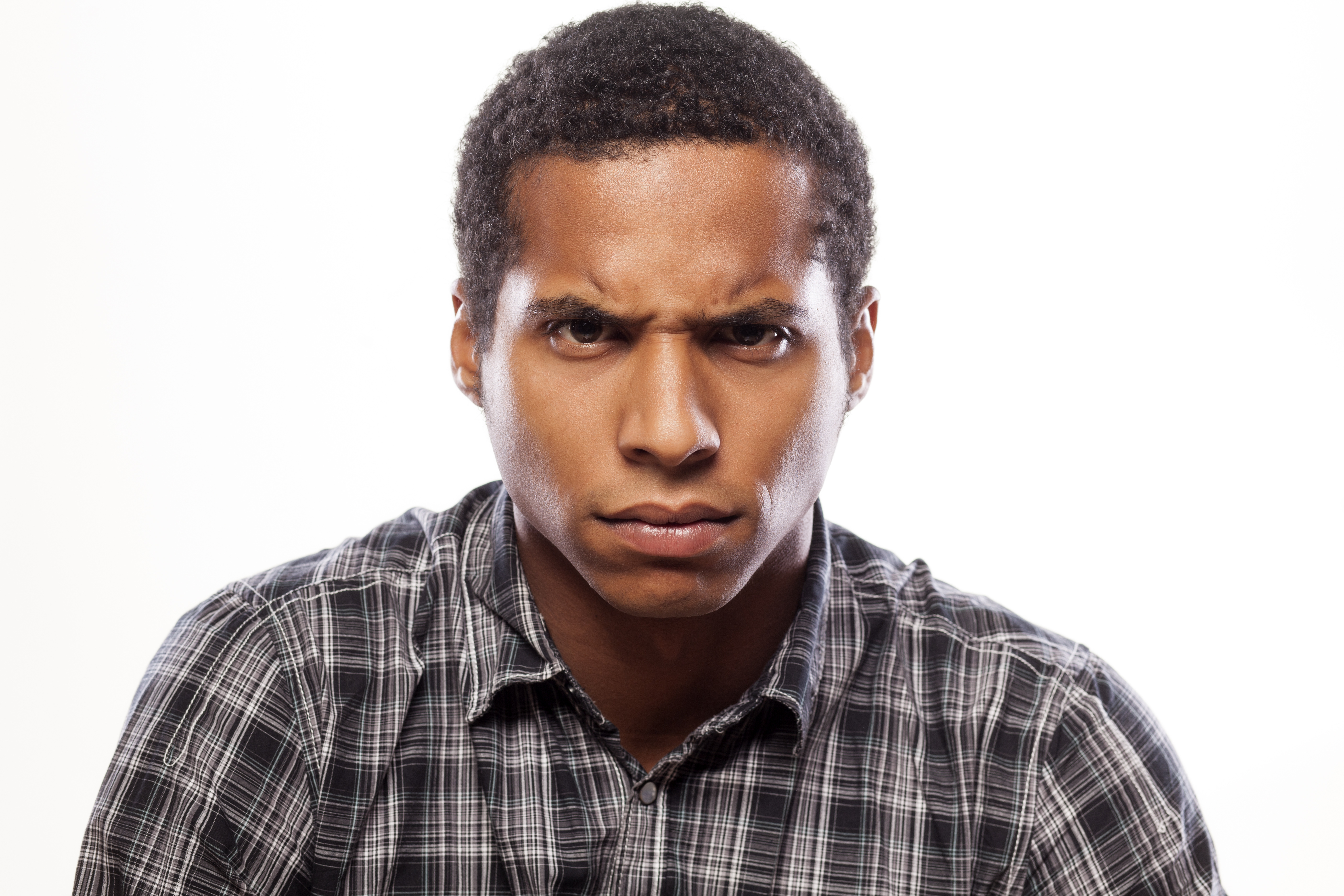 somber dark-skinned young man poses with angry expression - Jay Harold